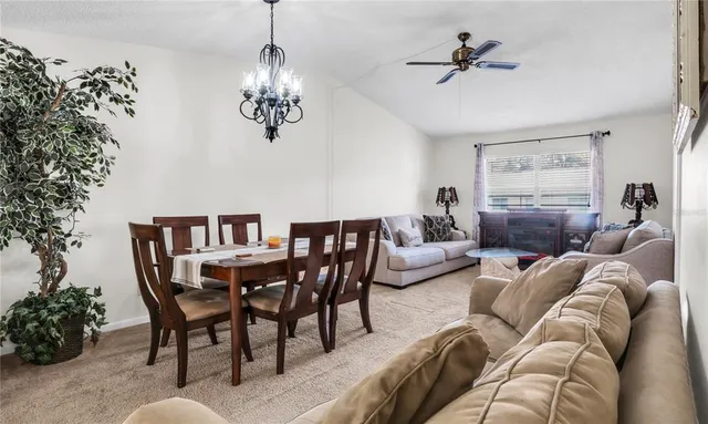a living room with furniture wooden floor and a chandelier