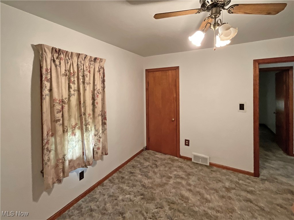 63 Mc Coll Road Colliers, WV 26035 - Photo 9 of 17 Empty room featuring carpet and ceiling fan