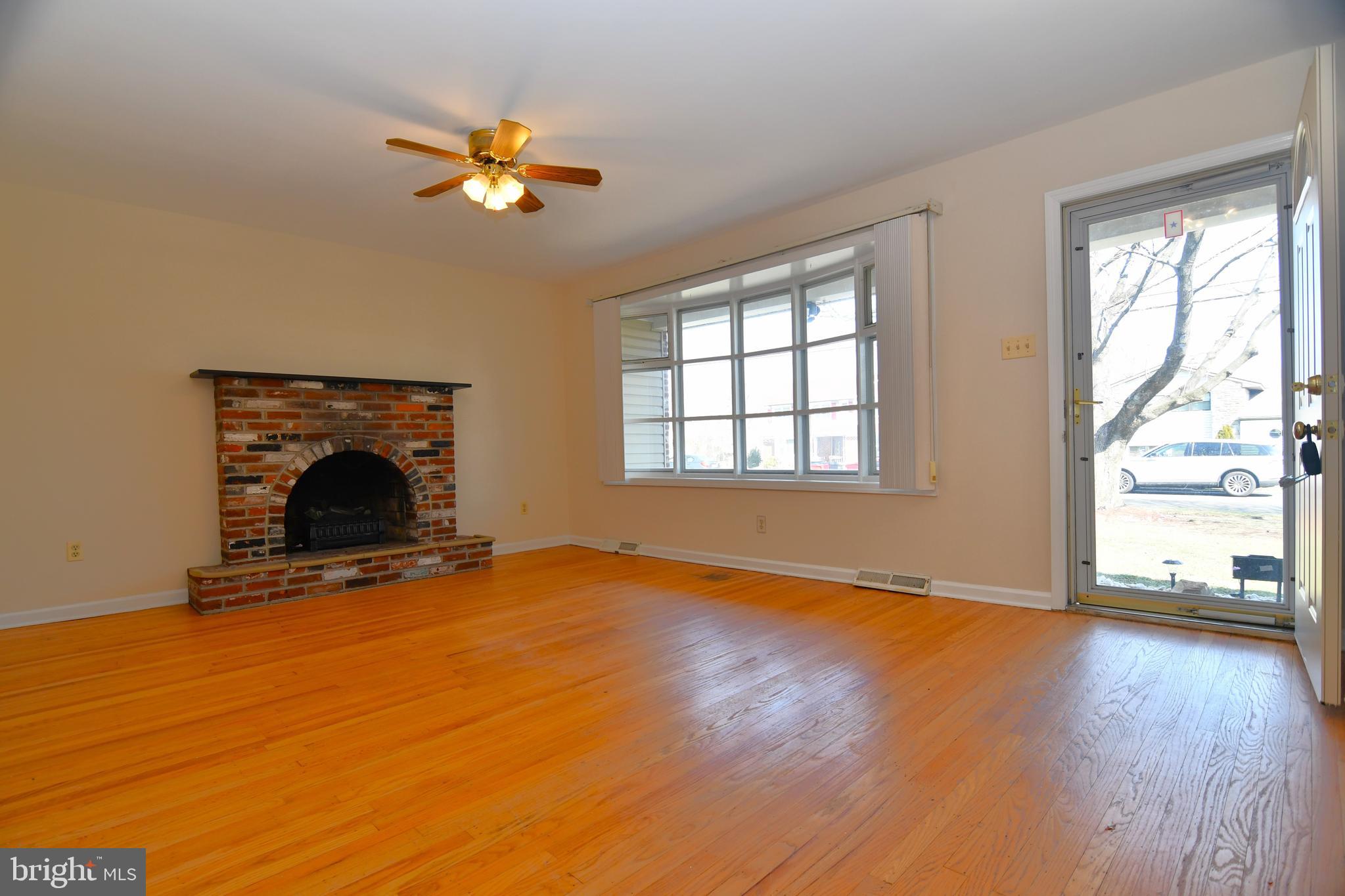 1492 Foster Road Warminster, PA 18974 - Photo 2 of 15 Formal Living Room w/ Brick Fireplace & Hardwoods!