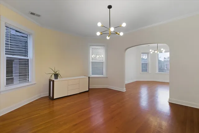 a view of a livingroom with wooden floor and a ceiling fan