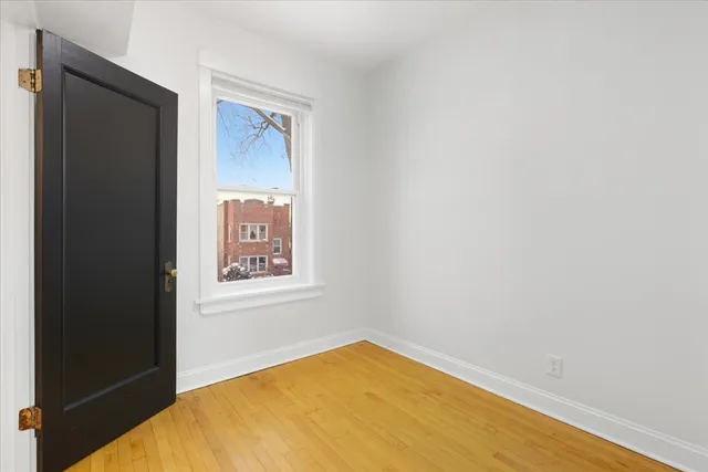 a view of a room with a wooden floor and a window