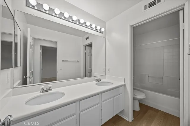 a bathroom with a double vanity sink and a bathtub