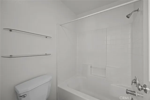 a bathroom with a shower and a toilet sink