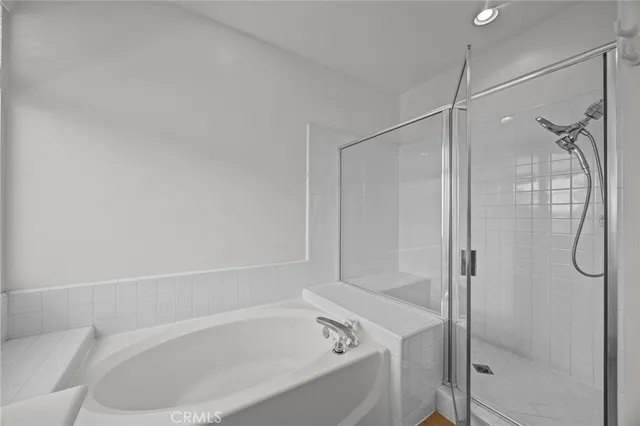 a bathroom with a bathtub and a shower