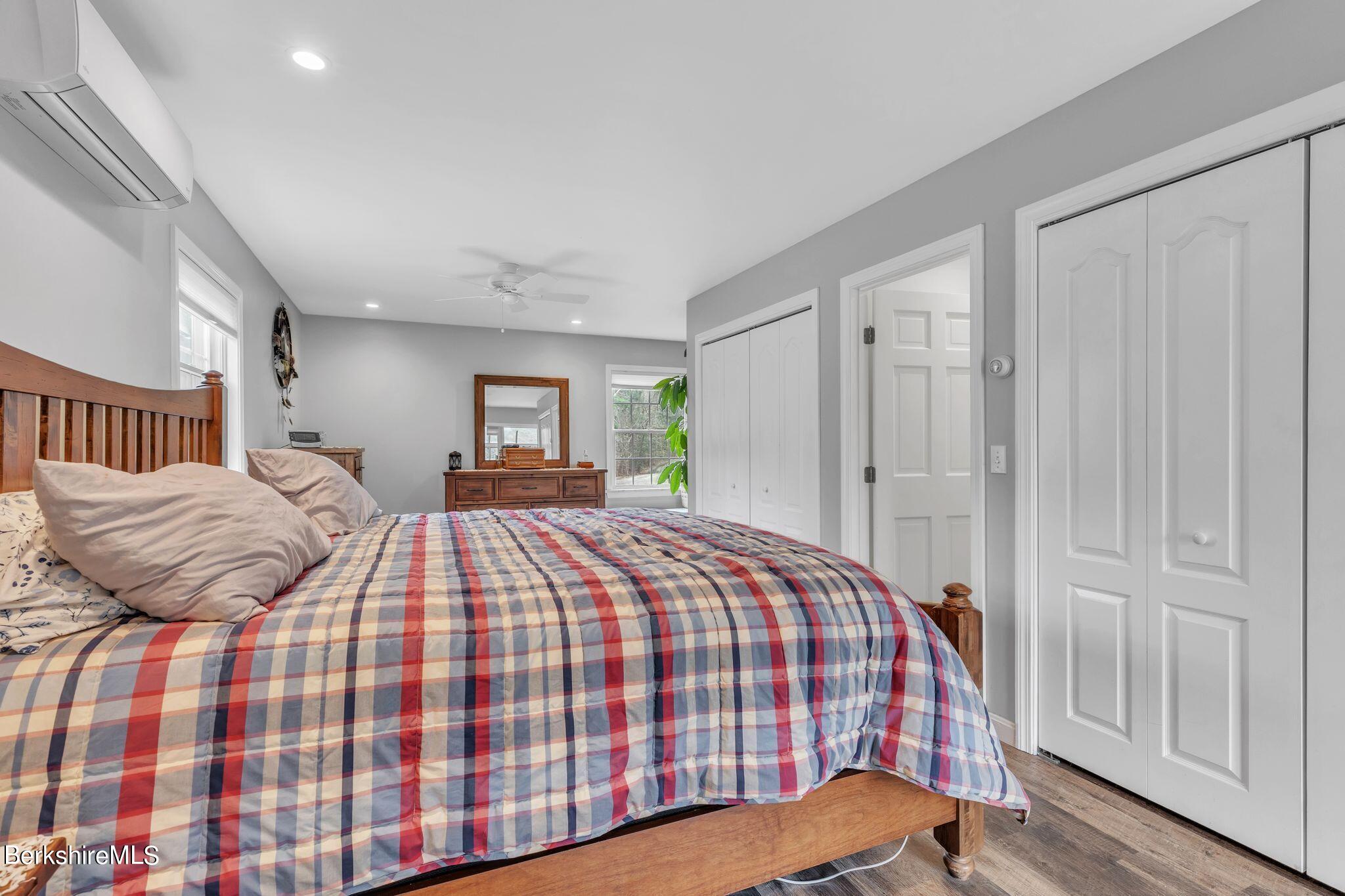 696 River Road Windsor, MA 01270 - Photo 16 of 42 a bedroom with a large bed and a chandelier