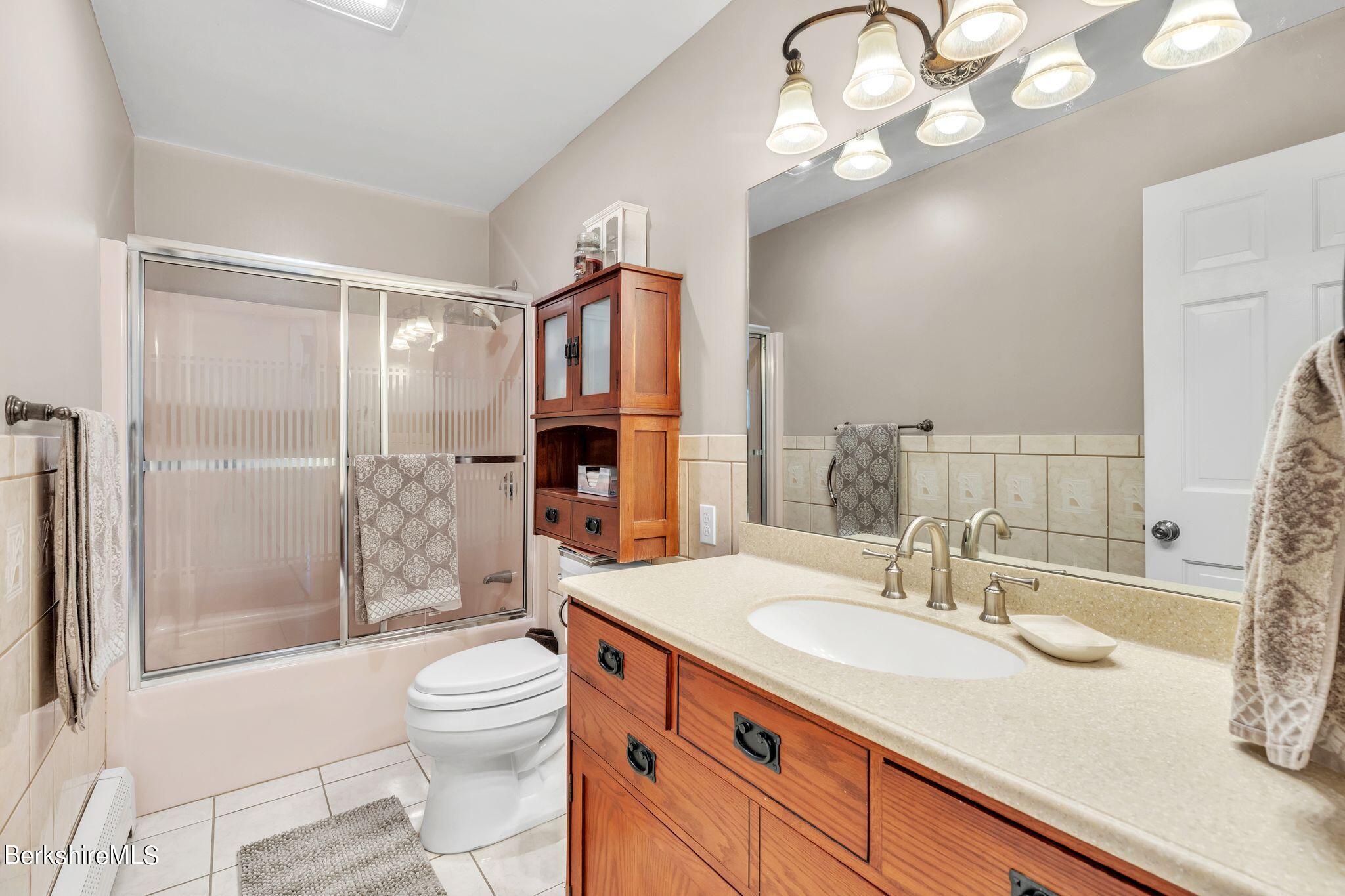 696 River Road Windsor, MA 01270 - Photo 22 of 42 a bathroom with a sink a toilet a mirror and shower
