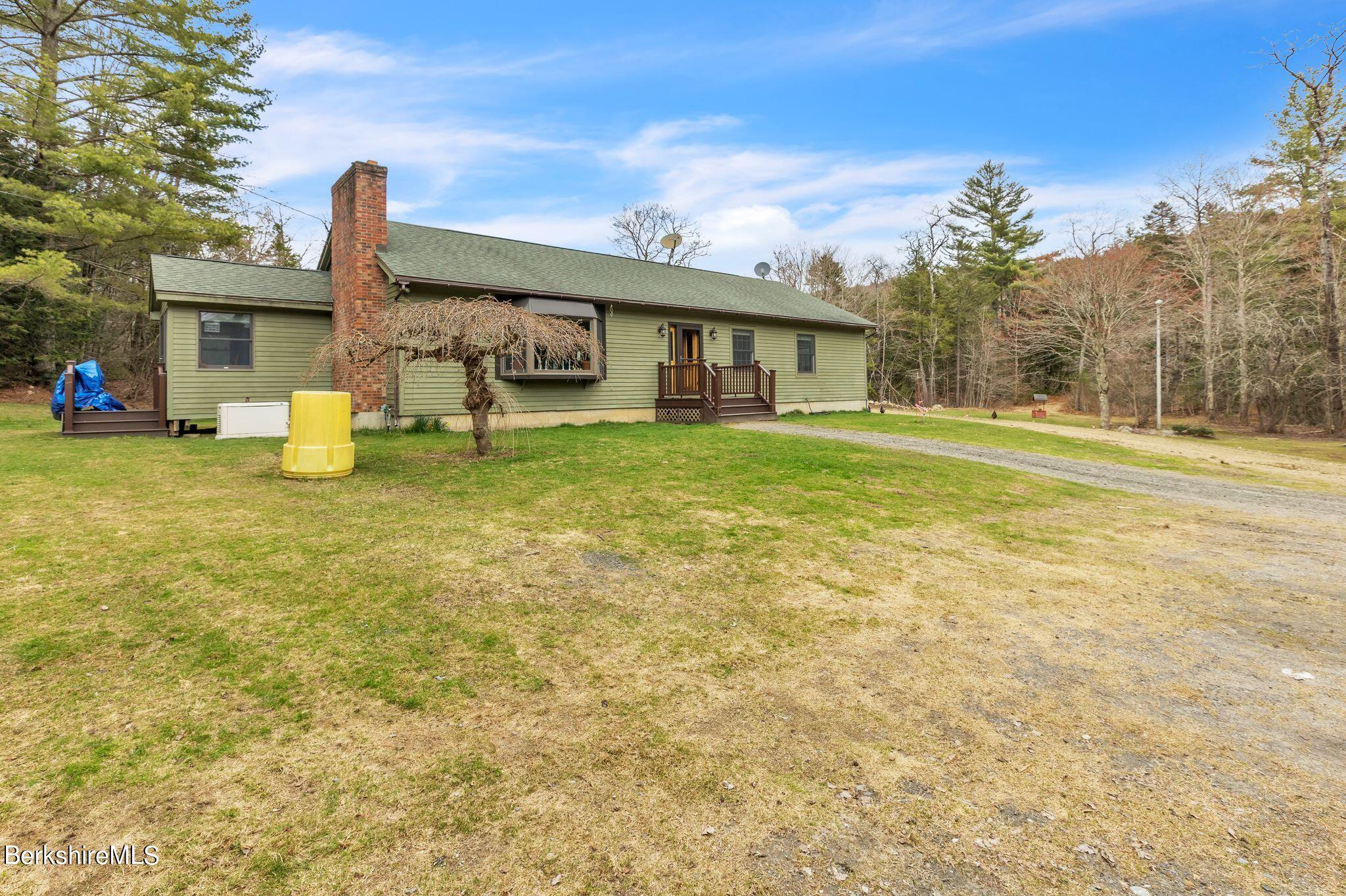 696 River Road Windsor, MA 01270 - Photo 26 of 42 a front view of a house with garden and porch