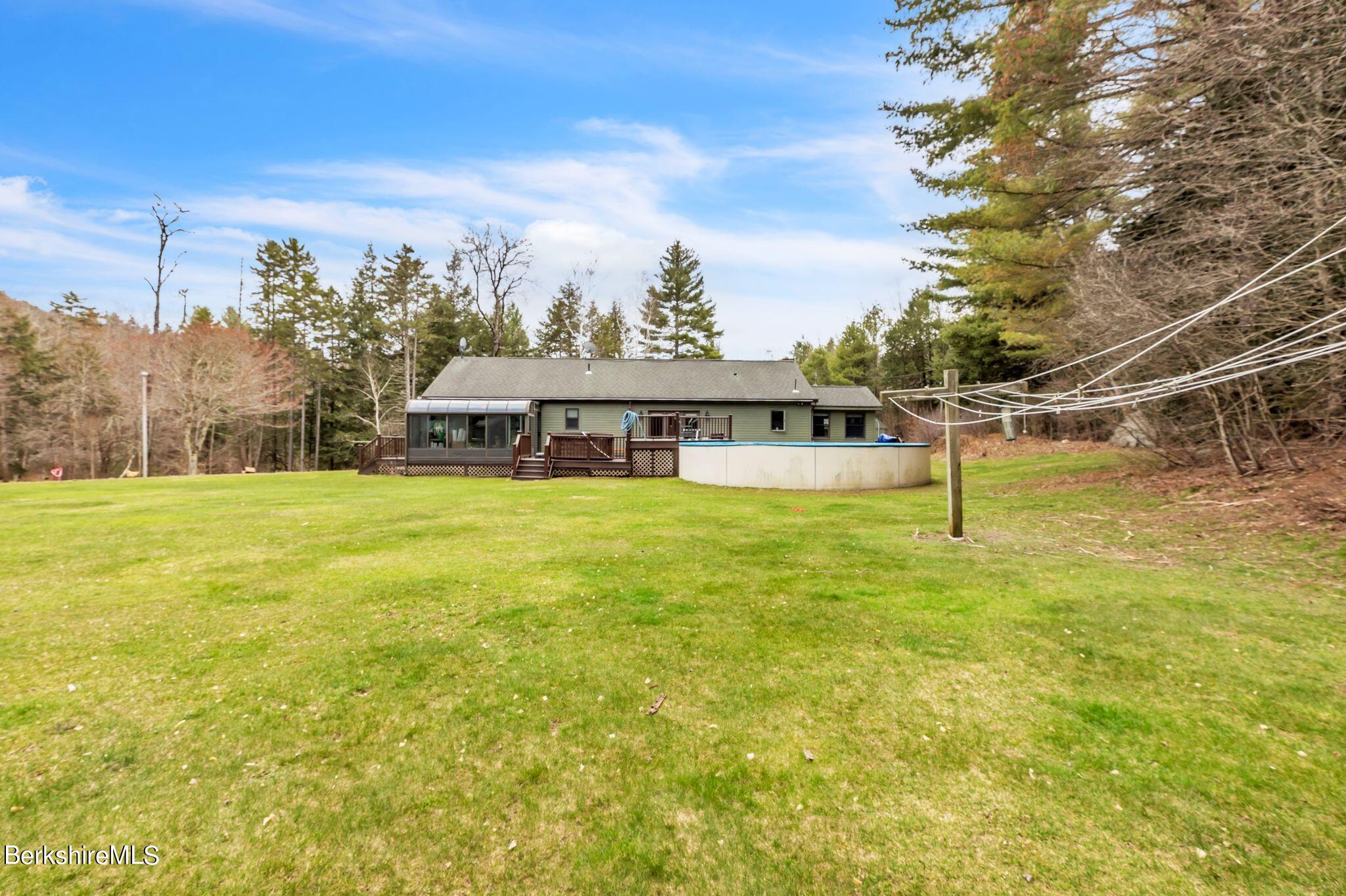 696 River Road Windsor, MA 01270 - Photo 27 of 42 a view of a swimming pool with an outdoor seating