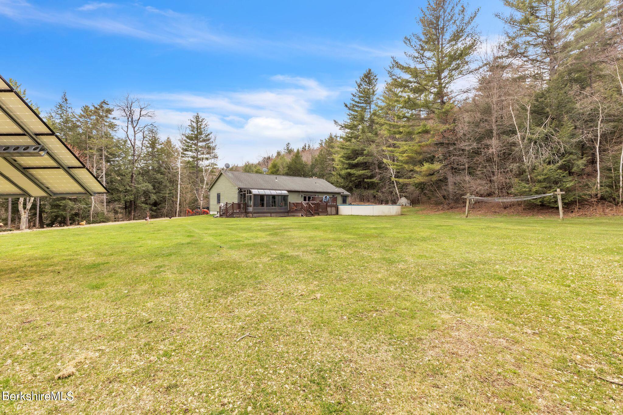 696 River Road Windsor, MA 01270 - Photo 28 of 42 a view of a swimming pool with an outdoor space and seating area