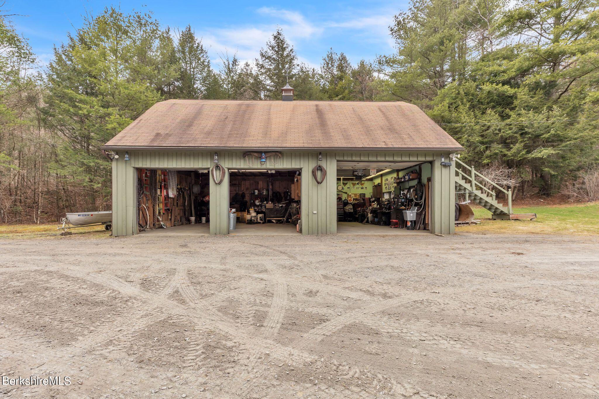 696 River Road Windsor, MA 01270 - Photo 30 of 42 a view of a house with a yard and garage