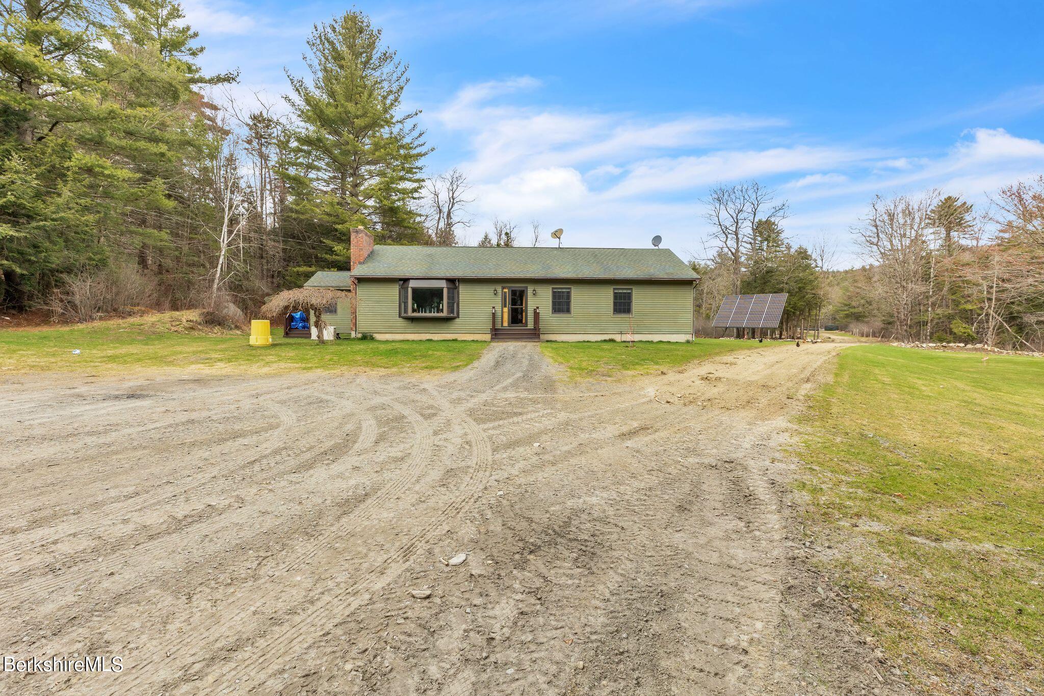 696 River Road Windsor, MA 01270 - Photo 3 of 42 a view of big yard with a house in the background