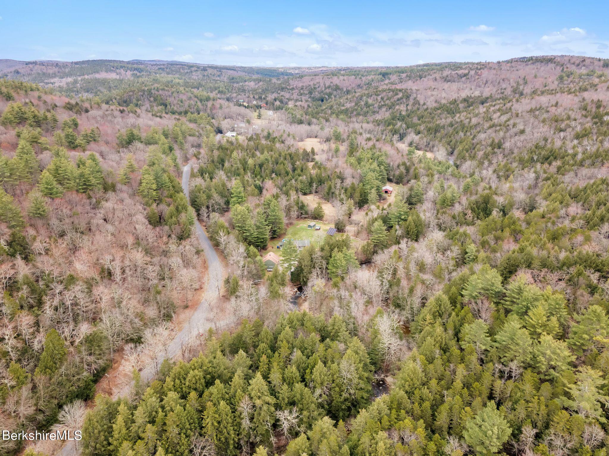 696 River Road Windsor, MA 01270 - Photo 40 of 42 a view of a city with lush green forest