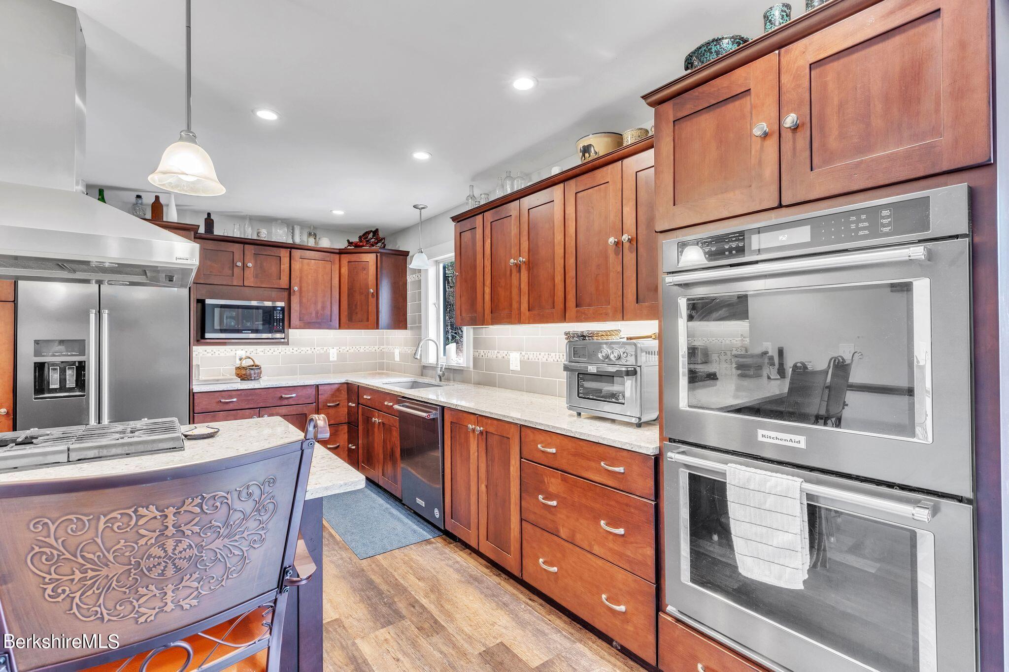 696 River Road Windsor, MA 01270 - Photo 5 of 42 a kitchen with stainless steel appliances granite countertop a sink stove and refrigerator