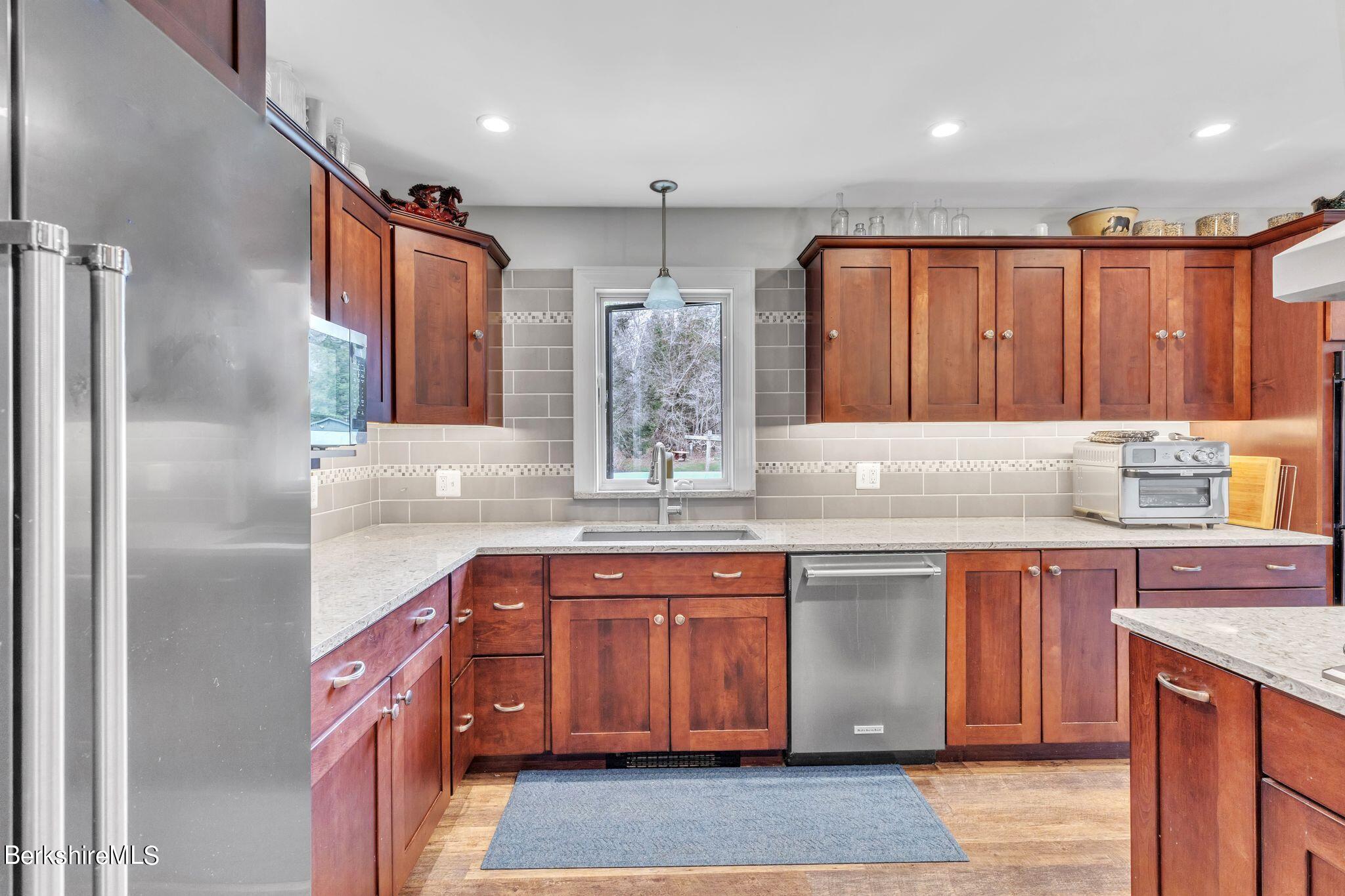 696 River Road Windsor, MA 01270 - Photo 7 of 42 a kitchen with stainless steel appliances granite countertop a sink a stove and a refrigerator