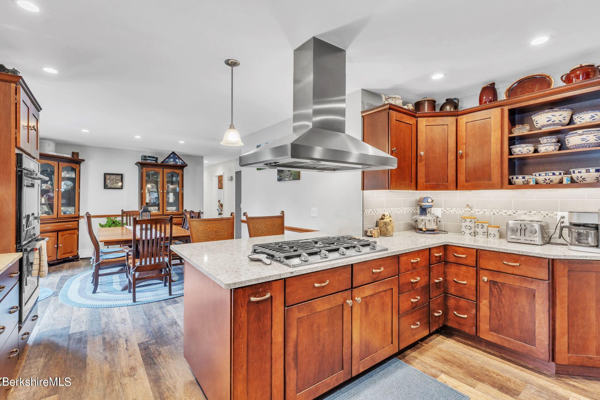 696 River Road Windsor, MA 01270 - Photo 8 of 42 a kitchen with granite countertop a sink stove and cabinets