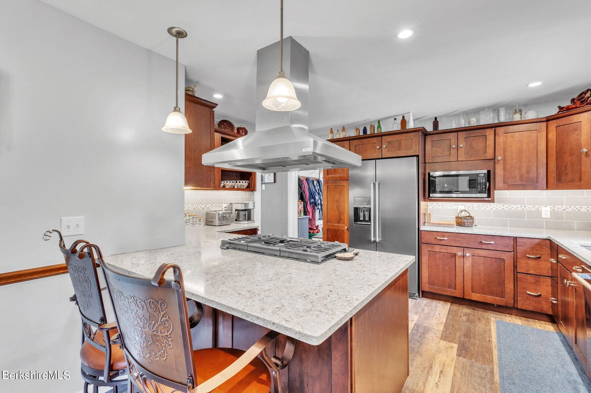 696 River Road Windsor, MA 01270 - Photo 9 of 42 a kitchen with stainless steel appliances granite countertop a kitchen island a stove and a cabinets