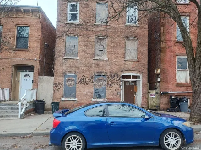 a front view of a house with parking space