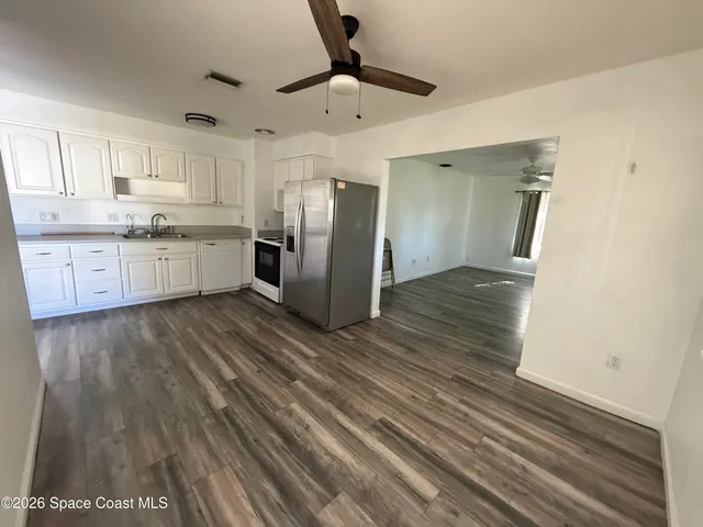 a kitchen with stainless steel appliances a refrigerator and a stove
