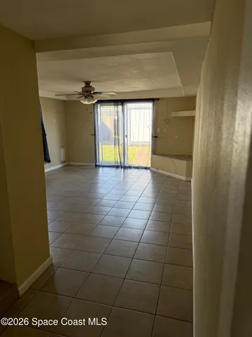 a view of an empty room and a window