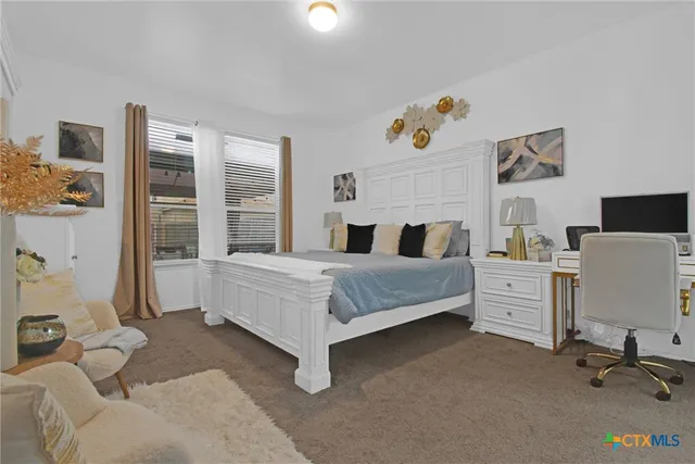 a bedroom with a bed and a desk