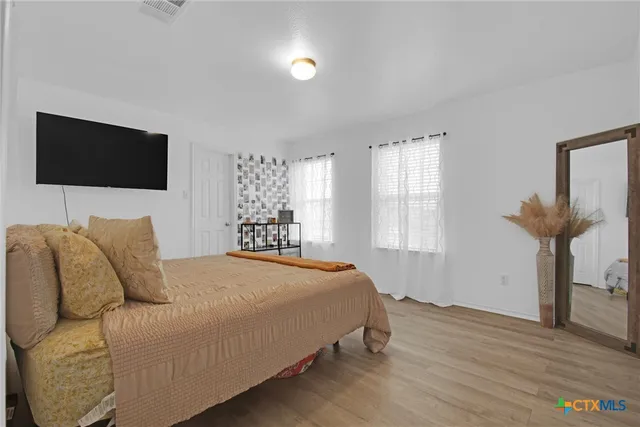 a bedroom with a bed and a chandelier