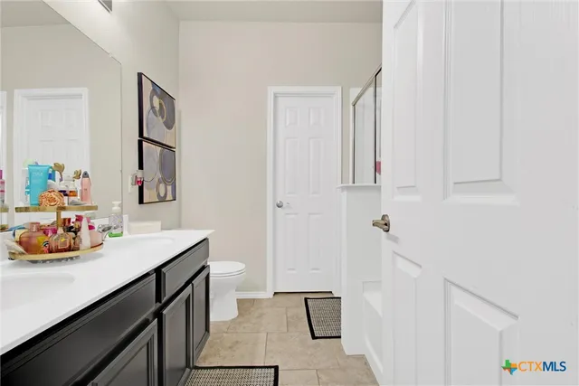 a bathroom with a sink mirror and vanity