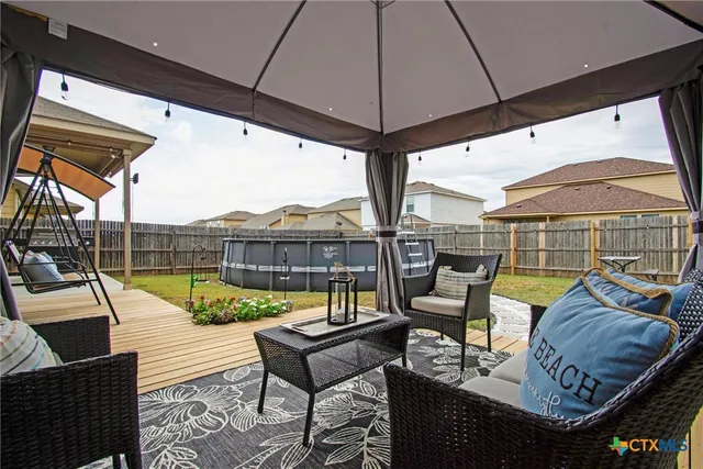 a view of a house with pool table and chairs