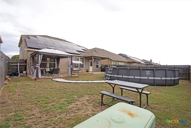 an aerial view of residential houses with outdoor space and swimming pool