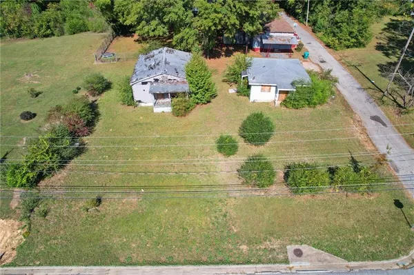 an aerial view of a house with a yard