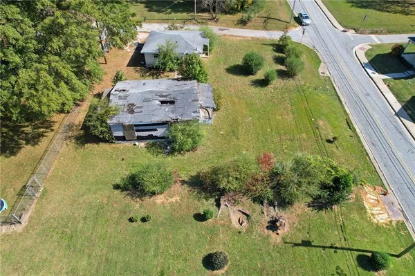 an aerial view of a house with a yard