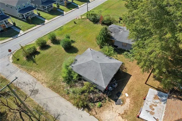 an aerial view of a house with a yard
