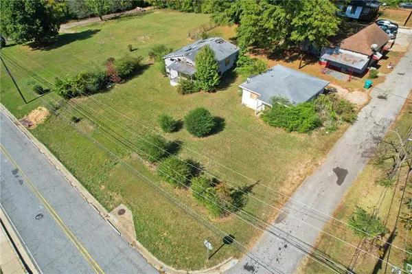 an aerial view of a residential houses with outdoor space