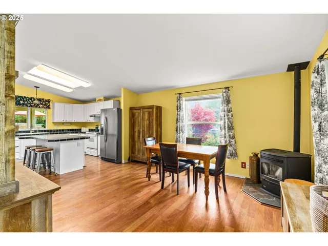 a dining room with furniture and wooden floor