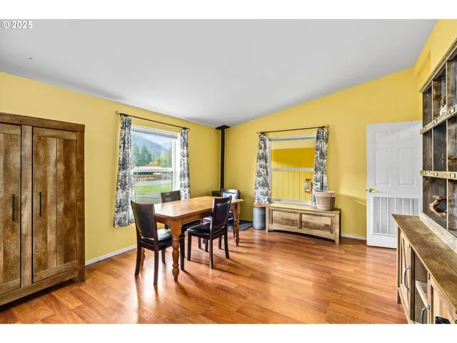 a view of a dining room with furniture window and wooden floor