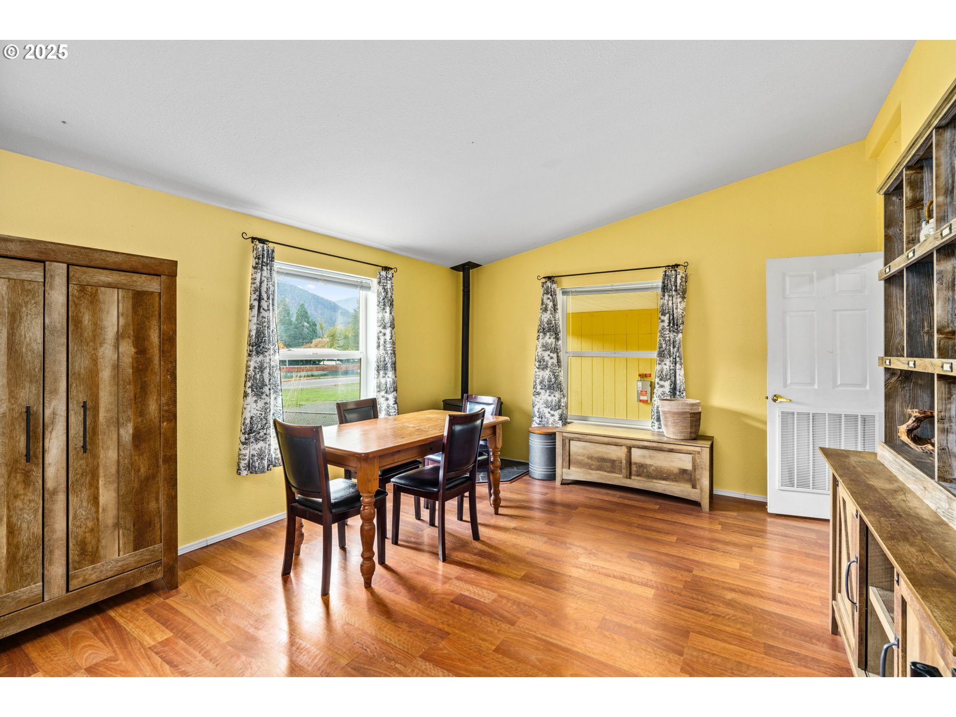 47849 West 2nd Street Oakridge, OR 97463 - Photo 13 of 45 a view of a dining room with furniture window and wooden floor