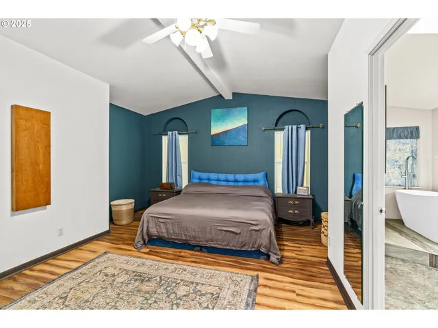 a bedroom with a bed a mirror and desk