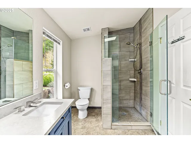 a bathroom with a sink toilet a shower and a mirror