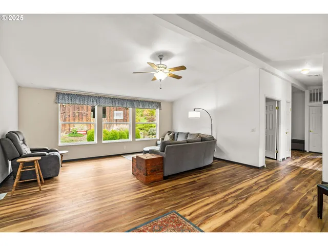 a living room with furniture window and wooden floor