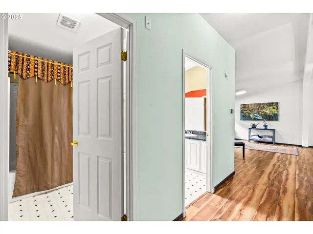 a view of a living room with a wooden floor