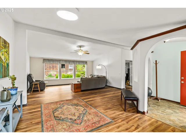 a living room with furniture rug and a table