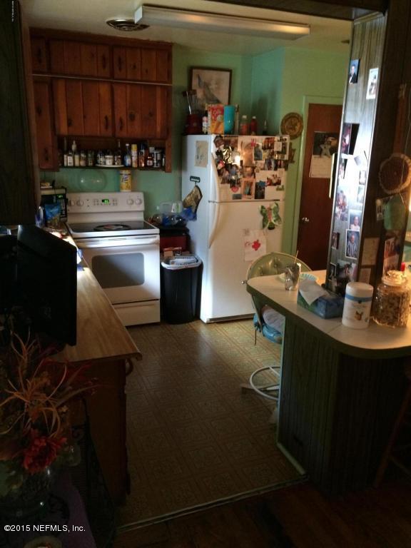3138 Rogero Road Jacksonville, FL 32277 - Photo 5 of 12 a living room with lots of furniture and clutter