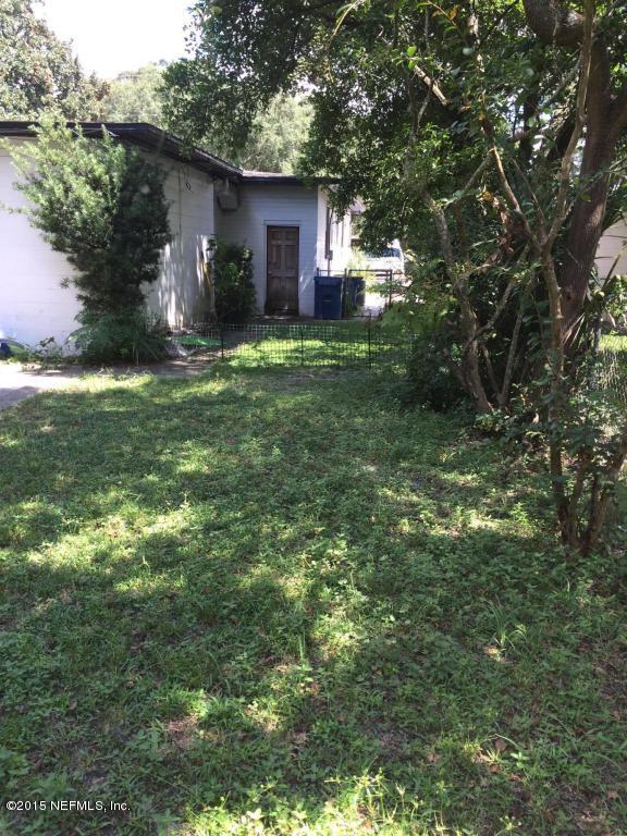 3138 Rogero Road Jacksonville, FL 32277 - Photo 8 of 12 a view of a house with a yard