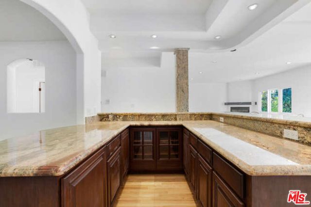 a view of living room with granite countertop furniture and wooden floor