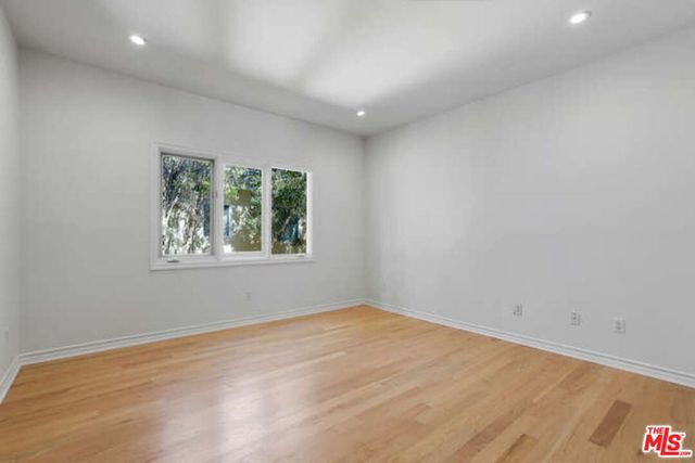 a bathroom with a granite countertop sink a toilet and bathtub