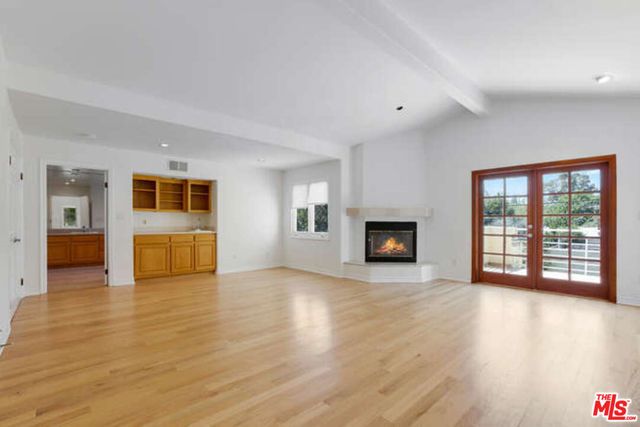 a view of a kitchen cabinets a sink wooden floor and a window