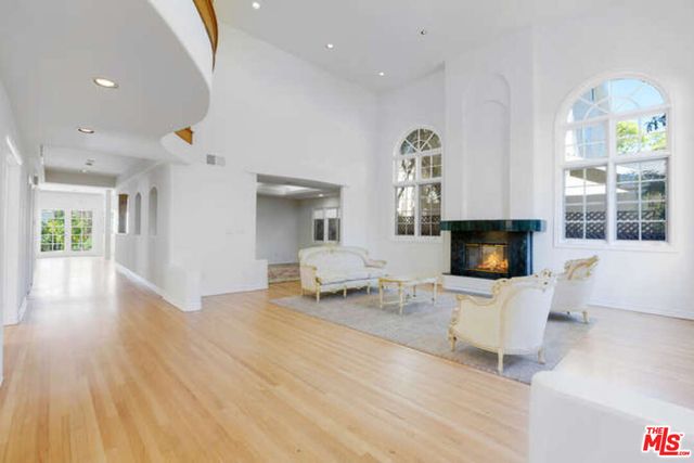 a living room with furniture window and wooden floor