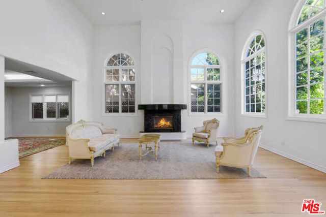 a living room with furniture and large windows