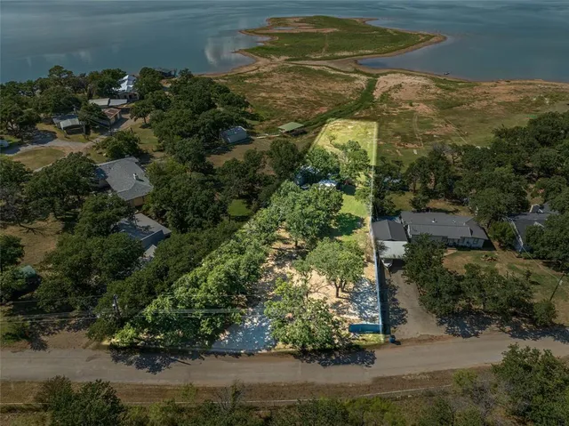 an aerial view of a houses with a yard