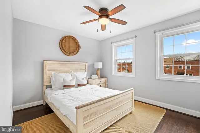 a bedroom with a bed and a large window