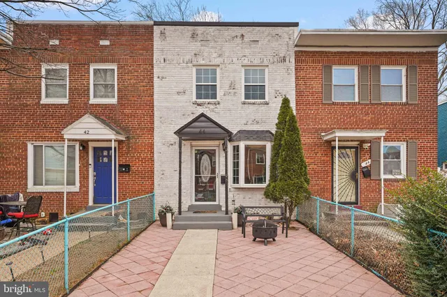 a front view of a house with outdoor seating